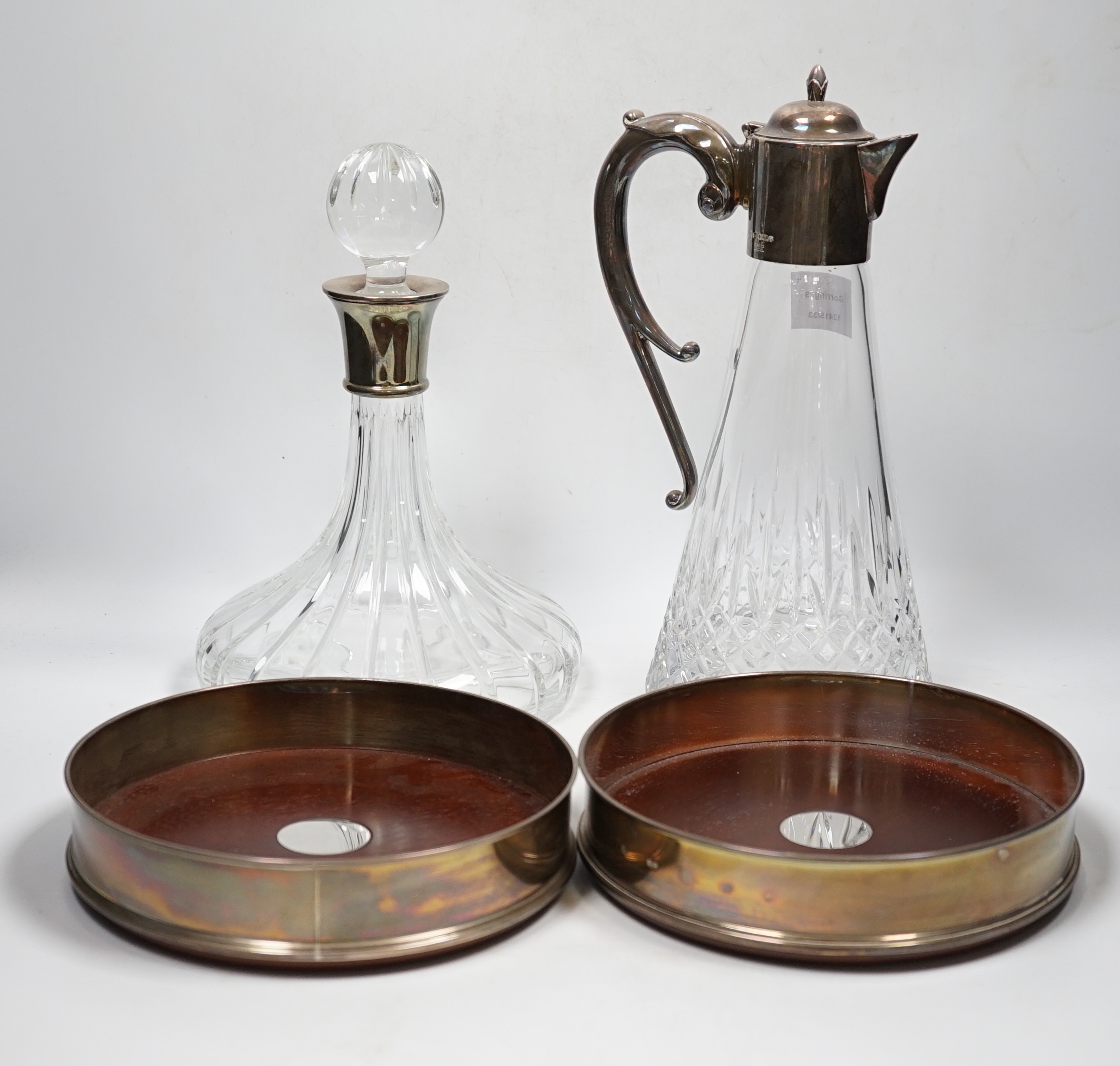 A Carr's of Sheffield modern silver mounted cut glass ship's decanter and stopper with matching silver mounted decanter coaster, Sheffield, 2007/8, one other similar decanter coaster and a silver mounted glass claret jug